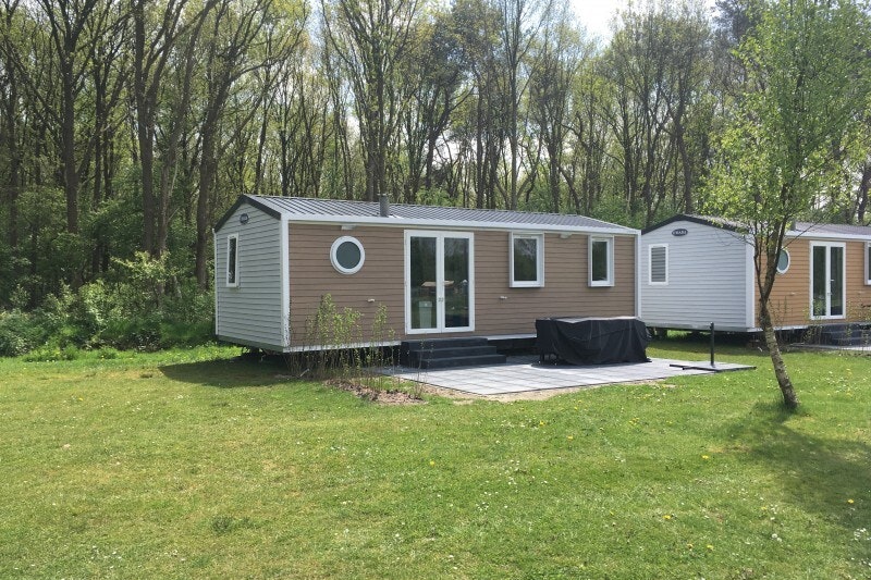 Ardoer Camping De Reeënwissel - Blick auf Mobilheim mit Terrasse auf dem Campingplatz