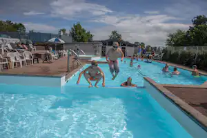 Blushøj Camping Ebeltoft - Pool im Freien mit Liegestühlen und Sonnenschirmen