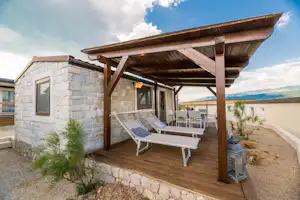 Camp Tiha Šilo - überdachte Terrasse mit Sitzmöglichkeiten einer Mediterranean Premium Mobilheim-Mietunterkunft