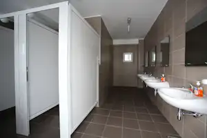 Camp Zlatibor - Sanitärbereich vom Campingplatz mit Waschbecken, Spiegeln, Toiletten und Duschen