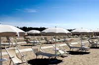 Camping Athena - Strand mit Liegestühlen und Sonnenschirmen auf dem Campingplatz