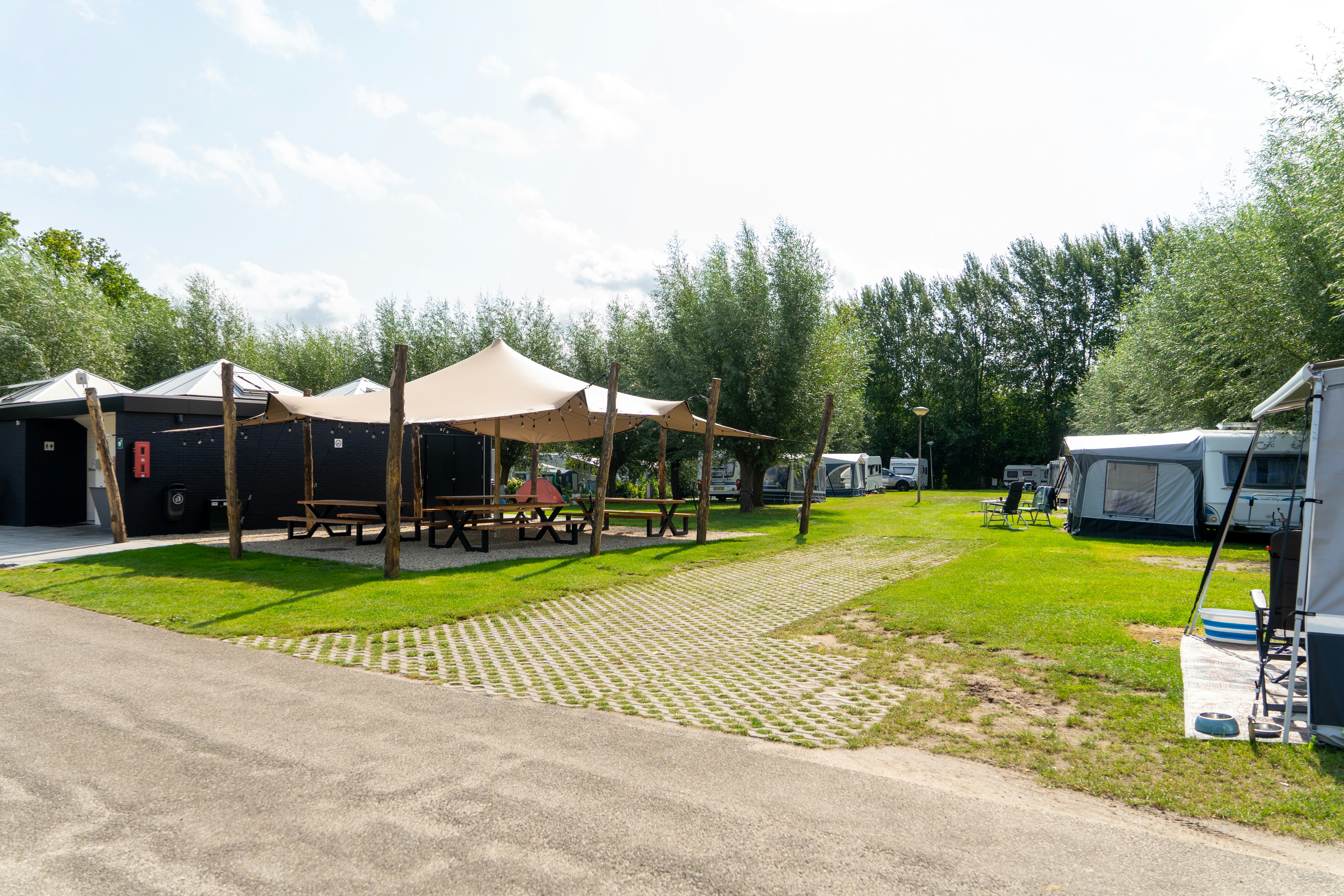 Camping Batenstein  BijBatenstein stadscamping Woerden - Sammelpunkt mit Picknicktischen und Sonnensegel
