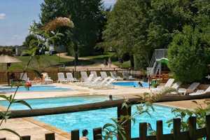 Camping Brin d'Amour - Poolbereich vom Campingplatz mit Wasserrutsche und Liegestühlen in der Sonne