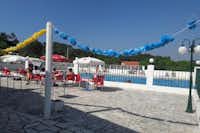 Camping Colina do Sol - Terrasse des Swimmingpools mit Sitzgelegenheiten und Sonnenschirmen