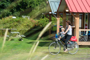 Camping De Kiekduun - Camperin mit Kind fährt Fahrrad auf dem Campingplatz
