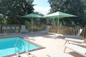 Camping de la Fontaine- Camping de La Fontaine - Pool im Freien mit Liegestühlen und Sonnenschirmen