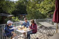 Camping de Lyon - Gäste beim gemeinsamen Frühstücken auf der Terrasse