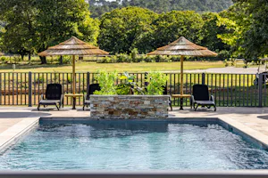 Camping Domaine des Chênes Verts - Pool im Freien mit Liegestühlen und Sonnenschirmen