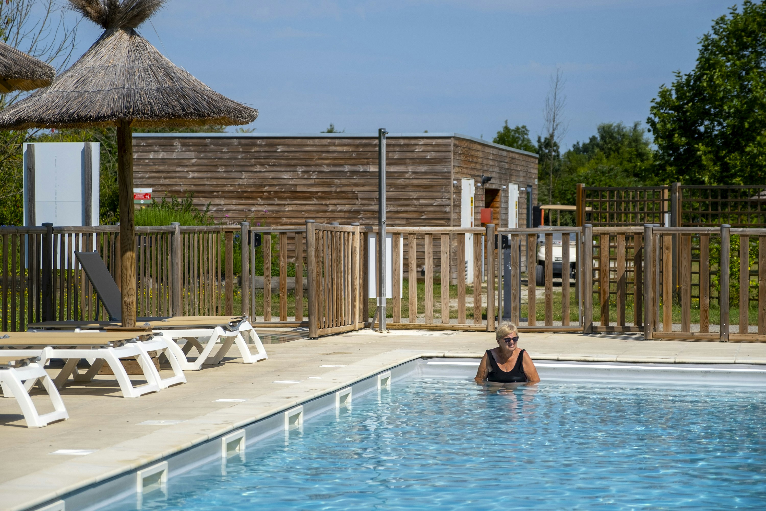Camping du Plan d'Eau  - Pool im Freien mit Liegestühlen und Sonnenschirmen