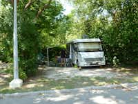 Camping du Pont d'Avignon - vor dem Wohnmobil sitzen Camper im Schatten