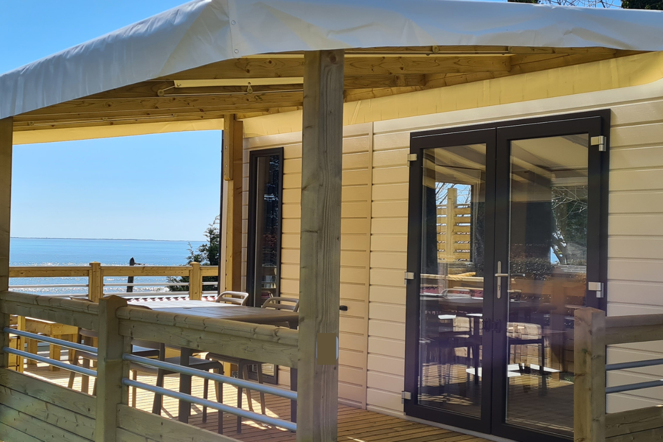 Camping Eléovic - Veranda des Mobilheims mit Blick aufs Wasser