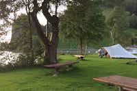 Camping Euthal - Zeltplätze in der Nähe des Sees und der Esstische auf dem Rasen 