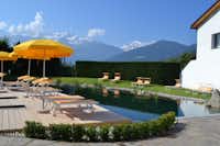 Camping Gloria Vallis -  Pool und Liegestühle mit Blick auf die Alpen- 