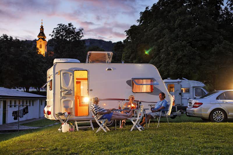 Camping Hartberg - Camper sitzen vor dem Wohnmobil im Schatten der Markise