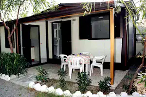 Camping il Gabbiano - Mobilheim mit Sitzbereich auf dem Campingplatz