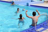 Camping International Le Raguenès Plage - Kinder spielen Wasserball im Swimmingpool