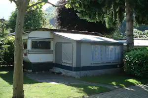 Camping Internazionale Paradis - Wohnwagen mit Vorzelt zwischen Bäumen