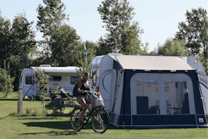Camping Julianadorp Aan Zee - Camperin mit Fahrrad neben den Standplätzen