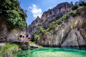 Camping La Fresneda - Camper beim Wandern an Felsen am kristallklaren Wasser