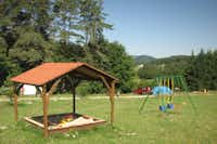 Camping La Vallée Verte - Kinderspielplatz mit Schaukeln und Sandkasten