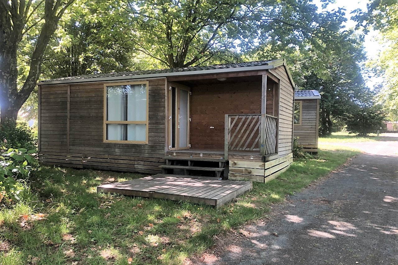 Camping le Petit Bocage - Mietunterkünfte mit Veranda im Halbschatten unter Bäumen gelegen
