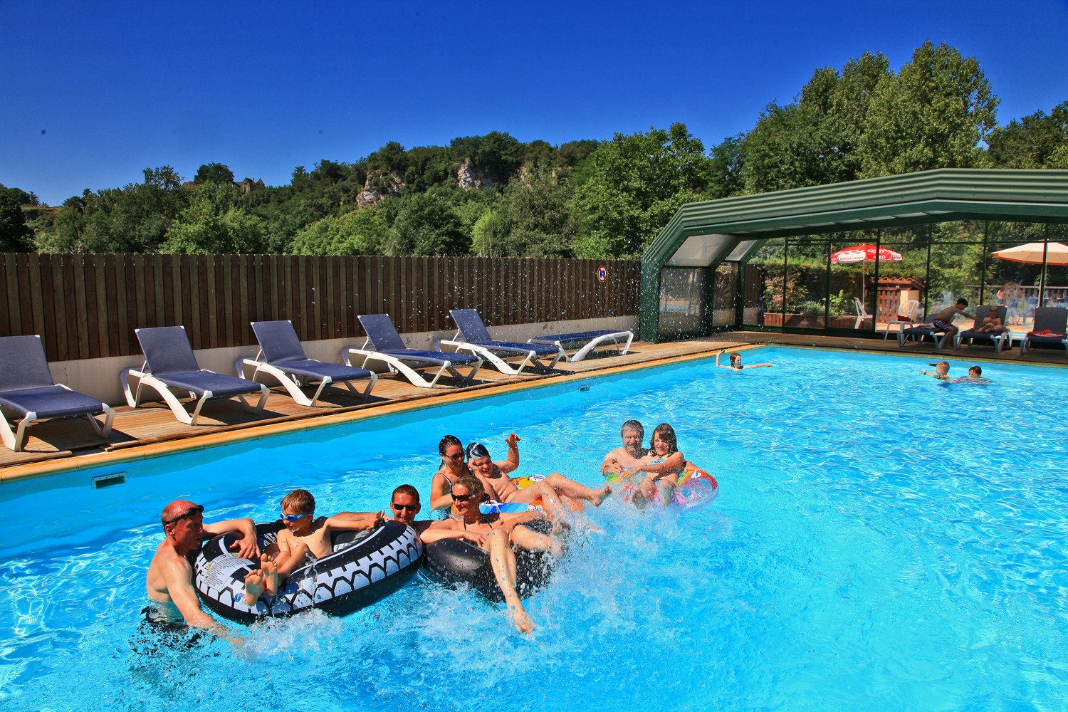 Camping Le Plein Air des Bories - - Campingplatzanlage mit Pool und Liegestühlen in der Sonne