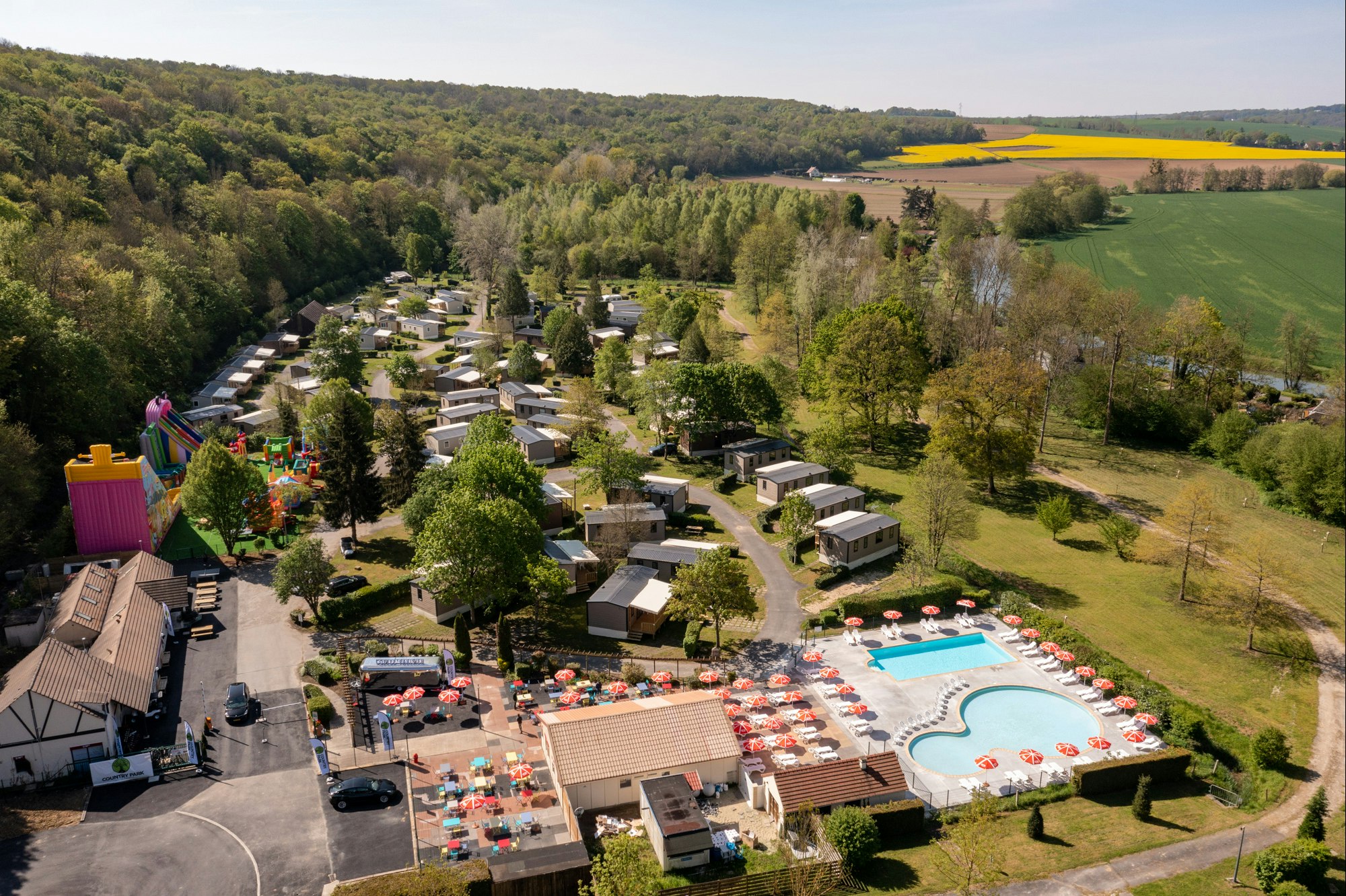 Camping Le Soleil de Crécy Vogelperspektive auf das Gelände des Campingparks mit Pools und Hüpfburgen