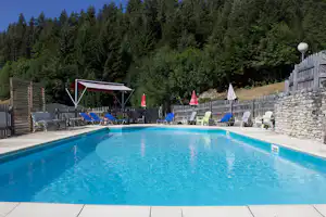 Camping Les Eymes - Pool im Freien mit Liegestühlen und Sonnenschirmen