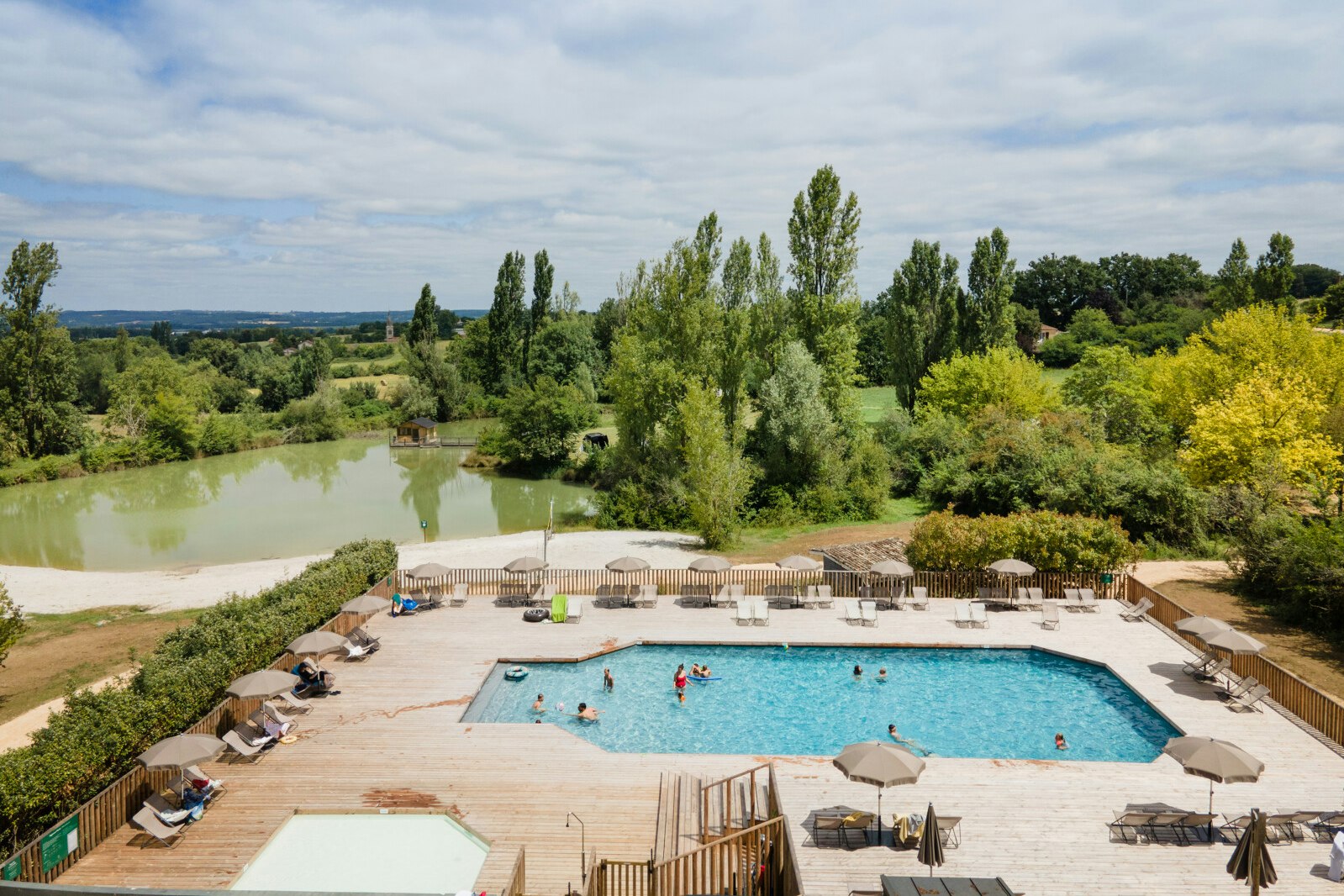 Camping Huttopia Vallée du Lot  Camping Les Ormes  - Pool im Freien mit Liegestühlen und Sonnenschirmen