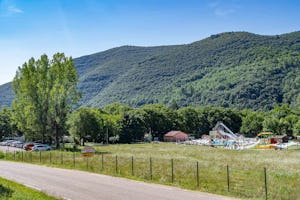 Camping Les Plans - Blick auf den Campingplatz umgeben von Wald und Hügeln