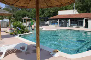 Camping Lou Cabasson - Pool mit Liegestühlen und Sonnenschirmen