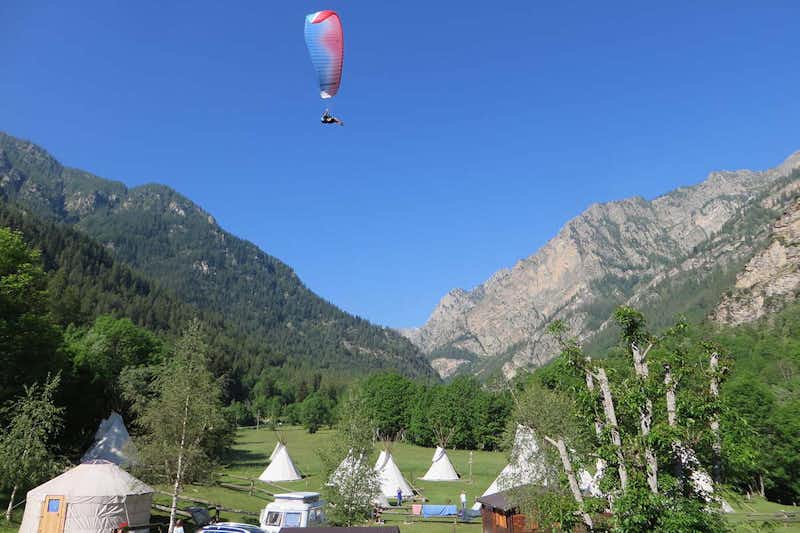 Camping Lou Dahu - Tipizelte auf dem Campingplatz mit einem Paraglider in der Luft