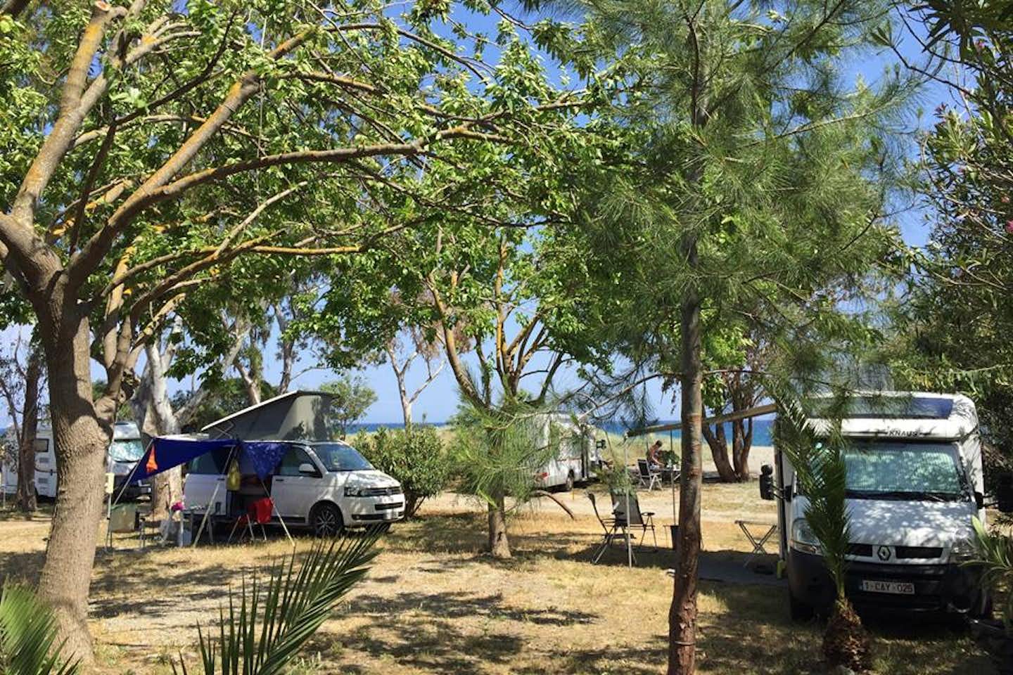 Camping Mani Beach  -  Stellplatz vom Campingplatz zwischen Bäumen mit Blick auf das Mittelmeer