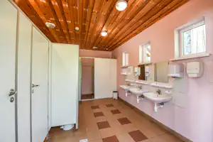 Camping Mindūnai - Innenansicht des Sanitärbereichs mit Waschbecken und Toilettenkabinen