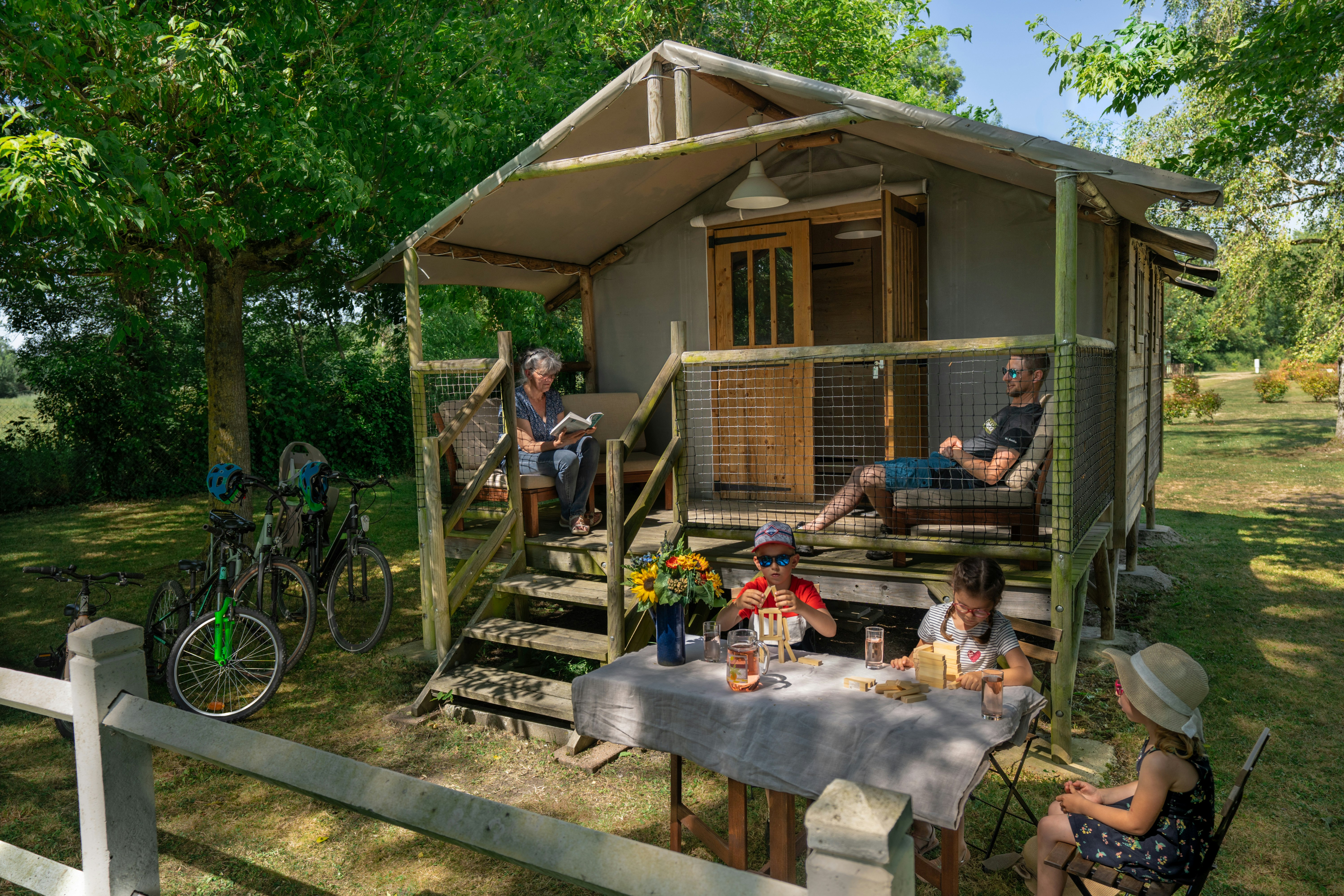 Camping Morédéna - Familie entspannt sich auf der Terrasse ihres Mobilheims