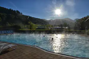 Camping Münstertal - Pool mit Liegestühlen und Sonnenschirmen auf dem Campingplatz