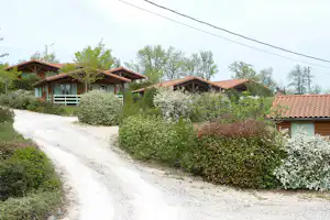 Camping Municipal du Plan d'Eau - Chalets an einer Strasse auf dem Campingplatz