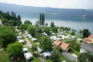 Camping Neubauer - Luftaufnahme auf die Wohnwagen- und Zeltstellplätze und den Millstättersee im Hintergrund