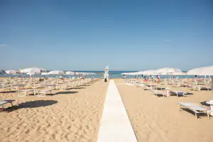 Camping Norina - Blick auf den Badestrand mit Liegestühlen und Sonnenschirmen