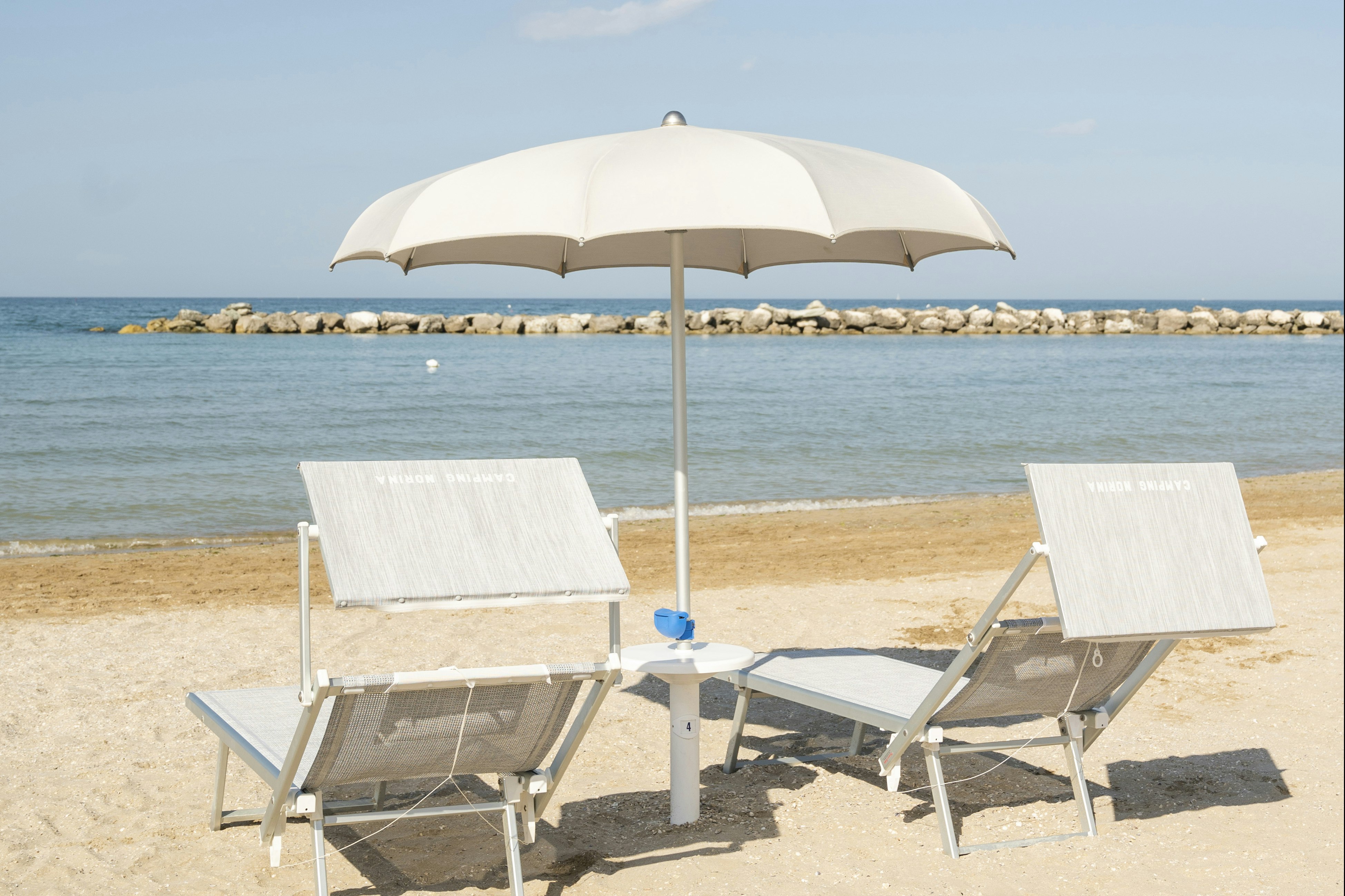Camping Norina - Liegestühle mit Sonnenschirm am Strand