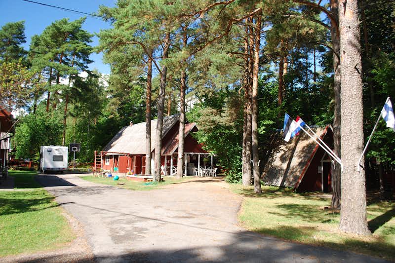Camping Pikseke - Hauptgebäude, Kinderspielplatz und und Waldhütte im Grünen auf dem Campingplatz