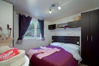 Camping Pineta - Schlafzimmer eines Mobilheims mit Doppelbett und Schrank