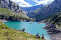 Camping Pyrénévasion - Wanderer vor einem Bergsee mit Gebirge im Hintergrund