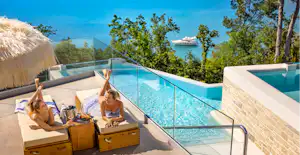 Lanterna Premium Camping Resort - Gäste beim Entspannen am Pool mit Meerblick