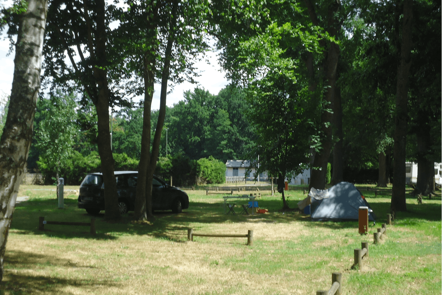 Camping Sauxillanges -Des Prairies d' Auvergne- - Wohnwagen- und Zeltstellplatz vom Campingplatz zwischen Bäumen