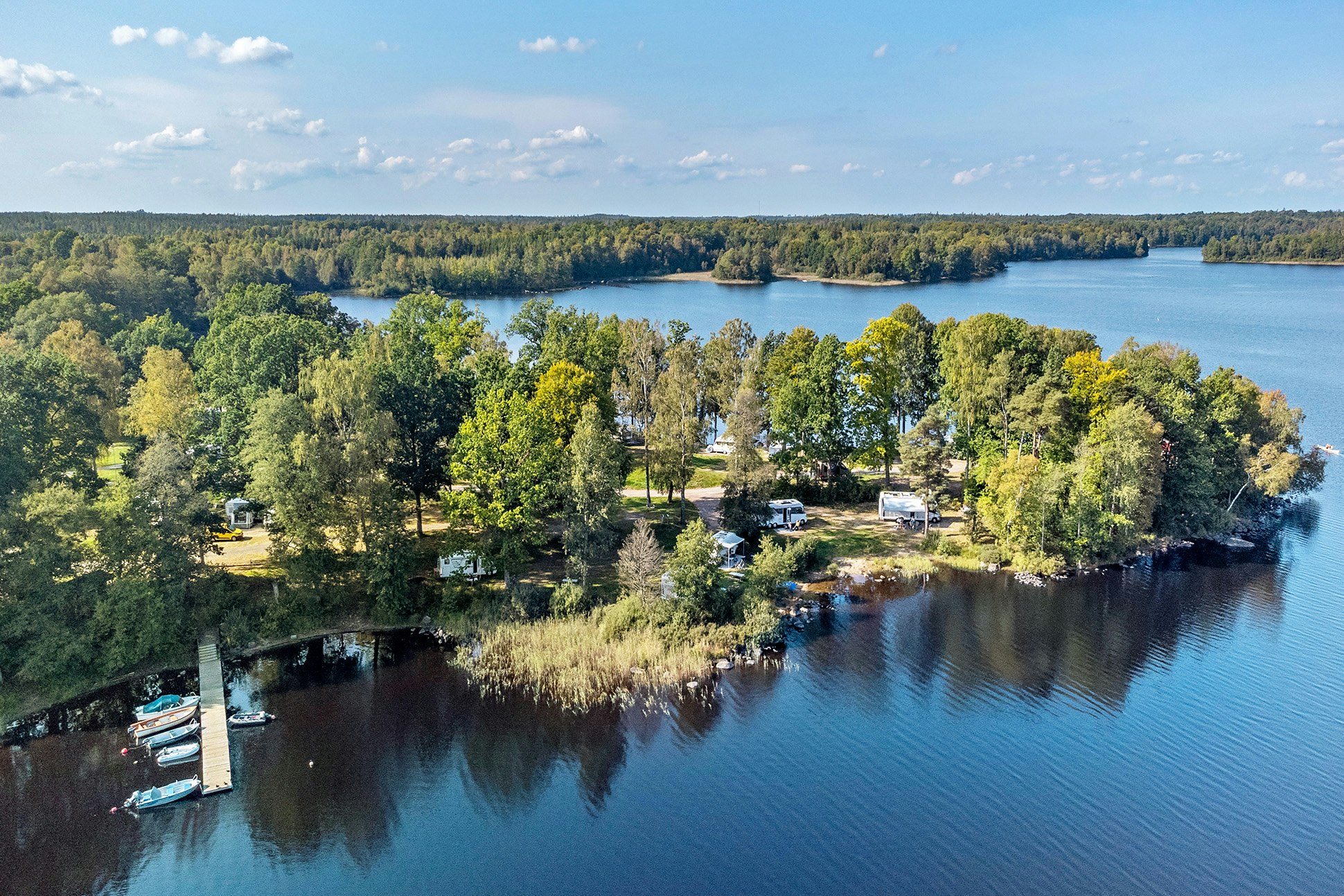 First Camp Sjöstugan – Älmhult  Camping Sjöstugan  - Luftaufnahme des Campingplatzes am Wasser