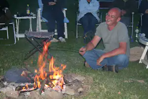 Camping Vidlák - Camper beim Würstchenbraten über dem Lagerfeuer