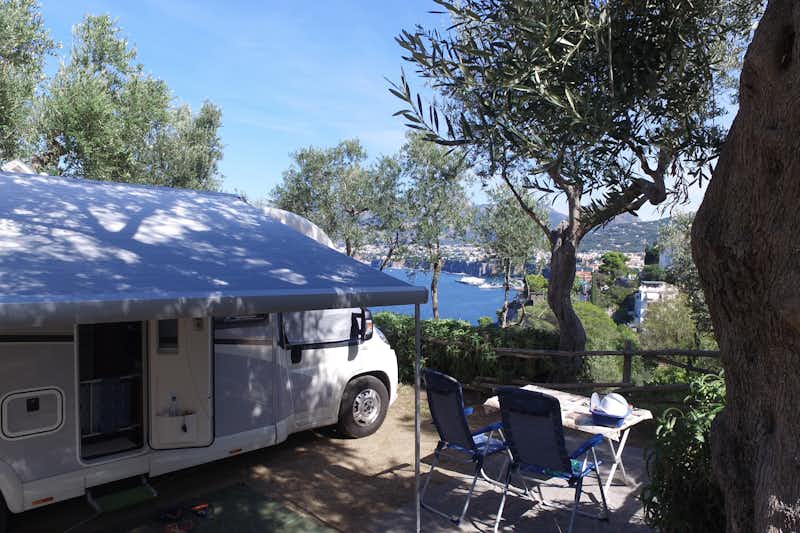 Camping Villaggio Santa Fortunata  -  Wohnmobil im Schatten von Bäumen mit Blick auf das Meer am Campingplatz