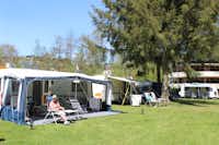 Camping Troisvierges - Wohnwagenstellplätze und Sanitärgebäude zwischen den Bäumen auf dem Campingplatz