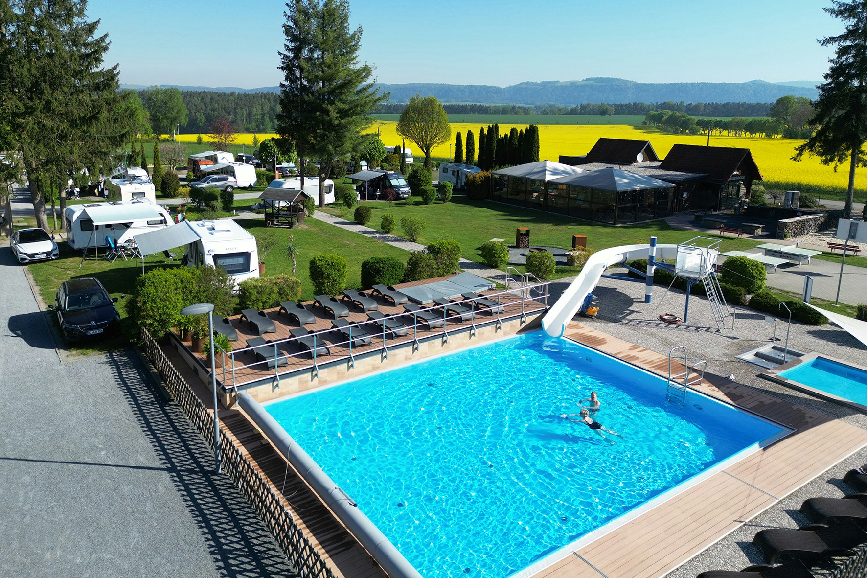 Caravan Camping Sächsische Schweiz - Pool im Freien mit Liegestühlen und kleiner Rutsche